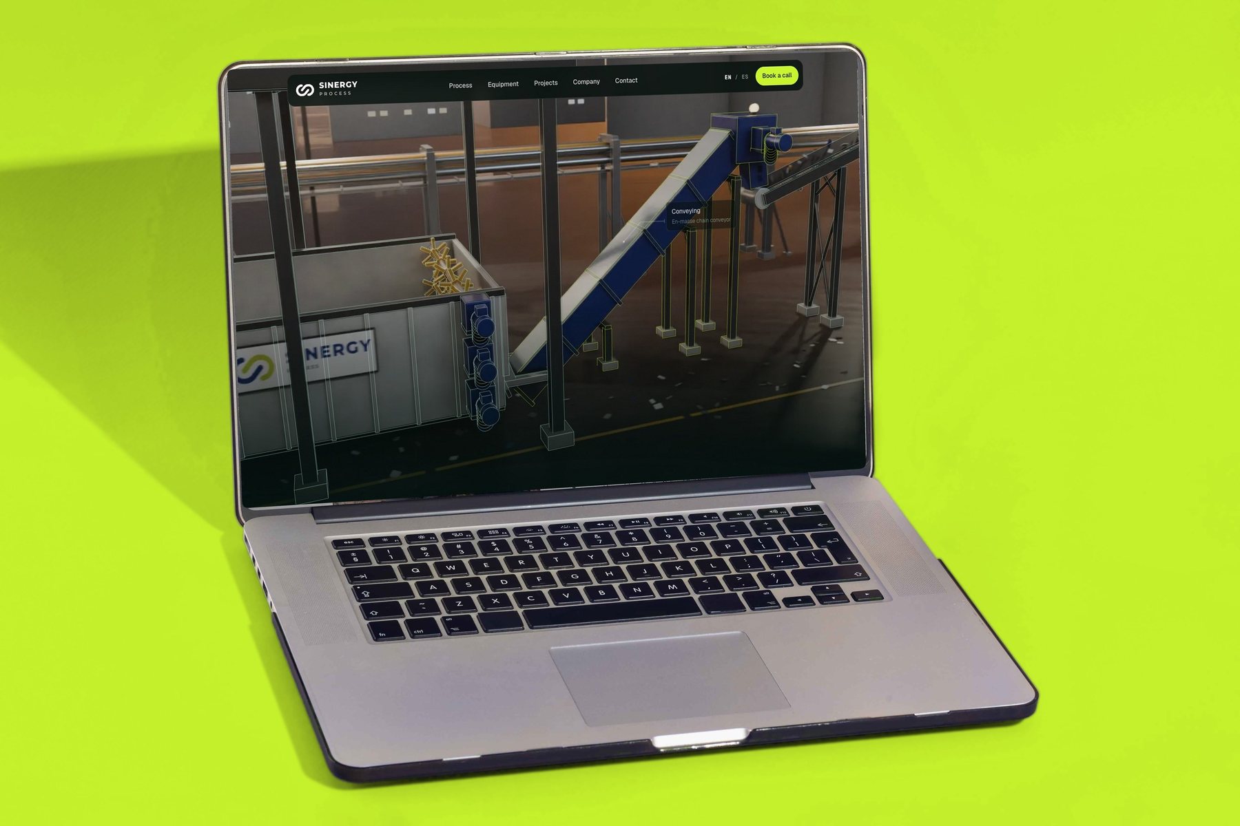 Sinergy Process website on a laptop, with the CAD drawn in lime over the receiving bunker and the conveyor